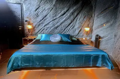 a bedroom with a large bed with blue pillows at Luxury Villa Eleven Eleven in San Rafael