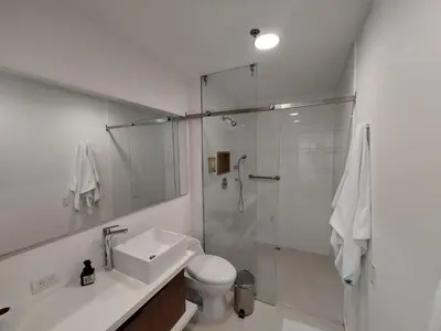 a bathroom with a shower and a toilet and a sink at Apartasuite en Rionegro, piscina, gimnasio y spa in Rionegro