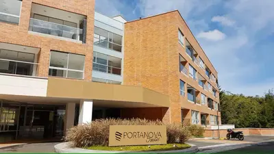 a brick building with a sign in front of it at Apartasuite en Rionegro, piscina, gimnasio y spa in Rionegro