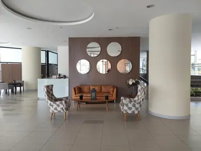 a lobby with a couch and chairs and mirrors at Apartasuite en Rionegro, piscina, gimnasio y spa in Rionegro