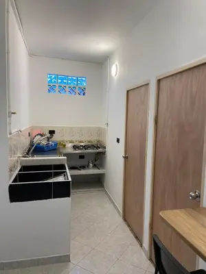 a kitchen with a sink and an open door at Apartmento a una cuadra del aprque principal in San Rafael