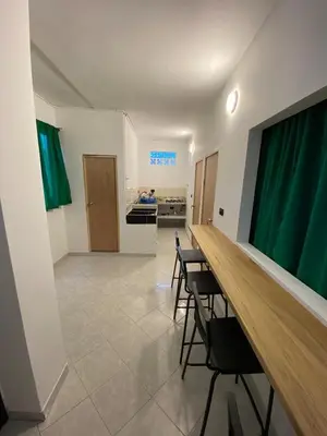 a room with a table and chairs and a kitchen at Apartmento a una cuadra del aprque principal in San Rafael