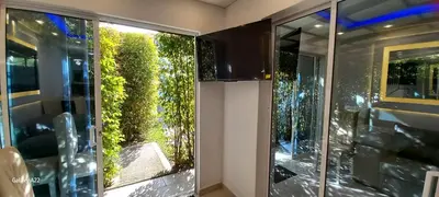 a room with glass doors with a garden outside at Hotel y Cabañas Parinzzi in Guatapé
