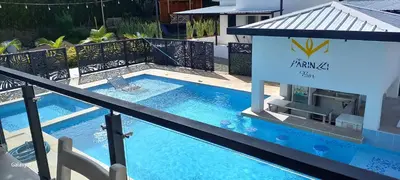 a hotel swimming pool with a sign on a balcony at Hotel y Cabañas Parinzzi in Guatapé