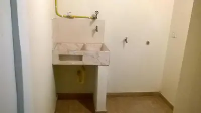 a bathroom with a sink in the corner of a room at Apartamento funcional cerca a Parque de Bello Antioquia in Bello