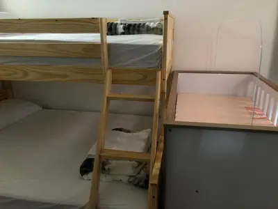 two bunk beds in a room with a ladder at Apartamento funcional cerca a Parque de Bello Antioquia in Bello