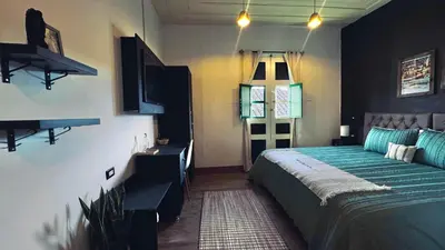 a bedroom with a bed and a window at Casa Mosaiko Sonsón in Sonsón