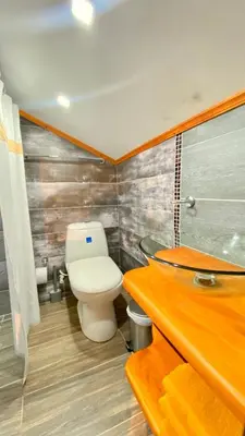 a bathroom with a toilet and a sink at Casa Mosaiko Sonsón in Sonsón