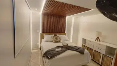 a bedroom with two beds and a dresser in it at Tu espacio cómodo, elegante y céntrico con balcón 401 in Medellín