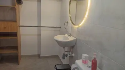 a white bathroom with a sink and a toilet at Tu espacio cómodo, elegante y céntrico con balcón 401 in Medellín