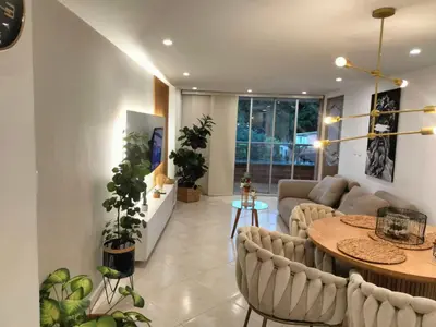 a living room with a couch and a table at Tu espacio cómodo, elegante y céntrico con balcón 401 in Medellín