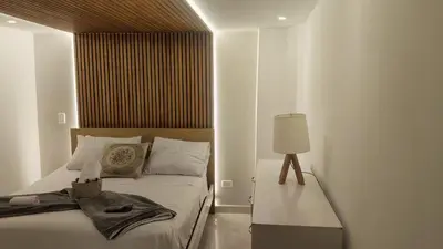 a bedroom with a bed with a lamp on it at Tu espacio cómodo, elegante y céntrico con balcón 401 in Medellín