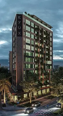 a tall building with cars parked in front of it at Kyux Building, Style and Comfort in Medellín