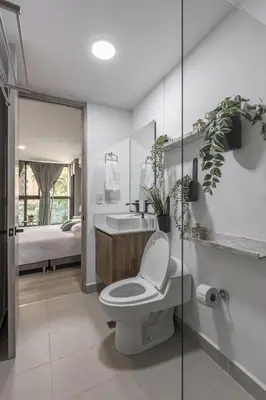 a white bathroom with a toilet and a sink at Kyux Building, Style and Comfort in Medellín