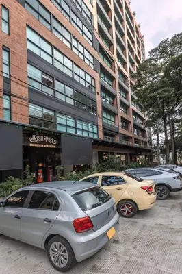 a group of cars parked in front of a building at Kyux Building, Style and Comfort in Medellín