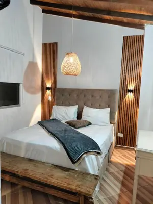 a bedroom with a bed and a pendant light at Ambiente natural y amplio, con vista panorámica de Medellín 501 in Medellín