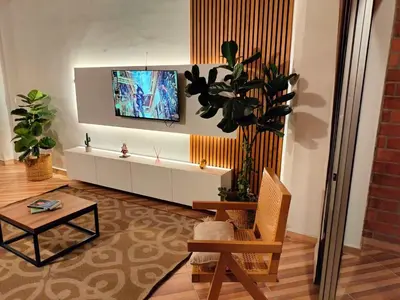 a living room with a tv on a wall at Ambiente natural y amplio, con vista panorámica de Medellín 501 in Medellín