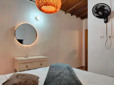 a bedroom with a bed and a mirror on the wall at Ambiente natural y amplio, con vista panorámica de Medellín 501 in Medellín