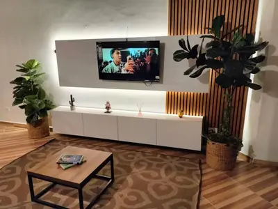 a living room with a tv on a wall at Ambiente natural y amplio, con vista panorámica de Medellín 501 in Medellín