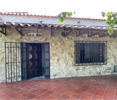 a stone building with a gate and a door at Casa MAVA in Mariquita