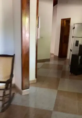 a empty hallway with a chair and a door at Casa MAVA in Mariquita