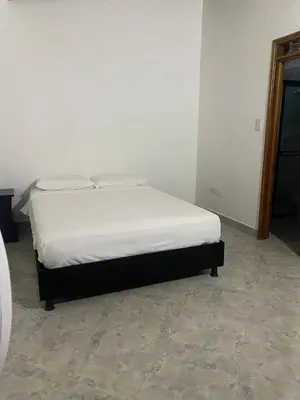 a bed in a room with a white mattress at Casa MAVA in Mariquita