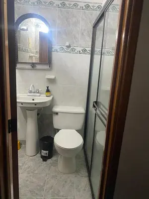 a bathroom with a toilet and a sink at Casa MAVA in Mariquita