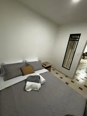 a bedroom with a bed with a dog laying on it at Apto 201 2H 2B Belén Fátima MUY bien ubicado in Medellín
