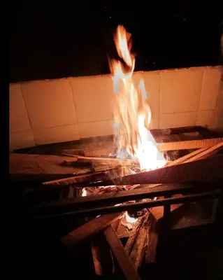 a fire is burning in a brick oven at Las Hamacas Mountain Hostal zona de camping in Villamaría