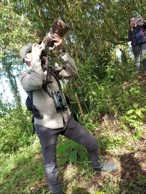 a man is taking a picture of a tree at Las Hamacas Mountain Hostal zona de camping in Villamaría