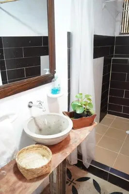 a bathroom with a sink and a shower at Eco Finca El Guadual - casa completa in Manizales