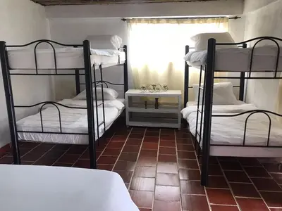 a room with two bunk beds and a window at Eco Finca El Guadual - casa completa in Manizales