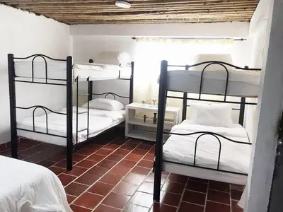 a room with three bunk beds in a room at Eco Finca El Guadual - casa completa in Manizales