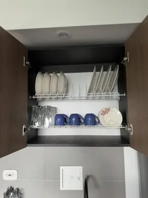 a cupboard filled with plates and pans and dishes at Apartamento cerca Terminal de Transportes y Cable aéreo in Manizales