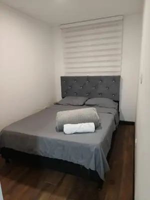 a bedroom with a large bed with a headboard at Apartamento cerca Terminal de Transportes y Cable aéreo in Manizales