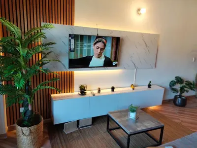 a living room with a tv on a wall at Inspirado en Bali con espectacular vista 502 in Medellín