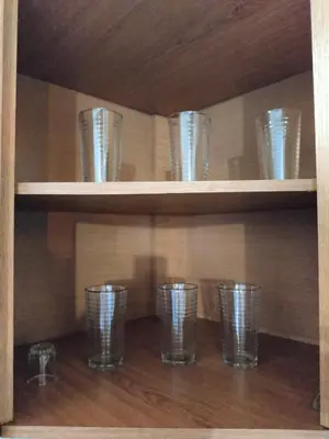a row of glasses on shelves in a cabinet at Inspirado en Bali con espectacular vista 502 in Medellín