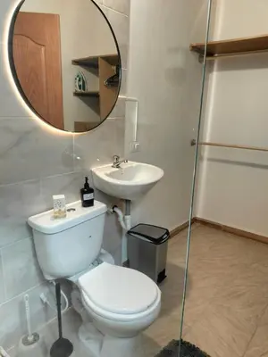 a bathroom with a toilet and a sink and a mirror at Inspirado en Bali con espectacular vista 502 in Medellín