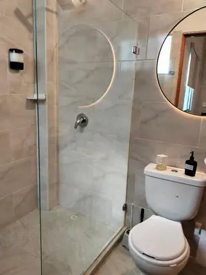 a bathroom with a shower with a toilet and a mirror at Inspirado en Bali con espectacular vista 502 in Medellín