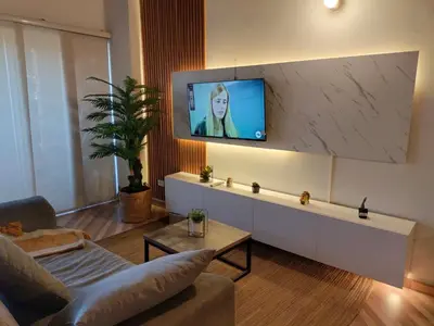 a living room with a tv on a wall at Inspirado en Bali con espectacular vista 502 in Medellín