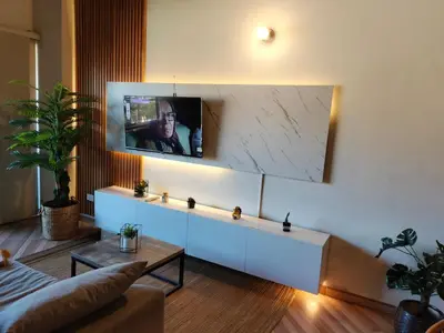 a living room with a tv on a wall at Inspirado en Bali con espectacular vista 502 in Medellín