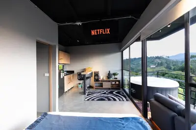 a bedroom with a tub and a view of a mountain at Roots Eco House in Guatapé