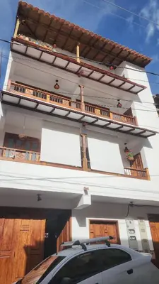 a white building with a car parked in front of it at Apartment in Tamesis in Támesis