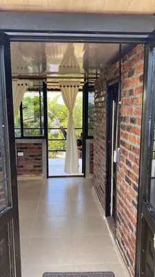 an open door with a wedding dress in the window at Cabaña con jacuzzi y piscina con agua de manantial in Norcasia