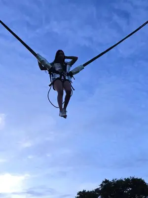 a woman on a rope in the sky at Cabaña con jacuzzi y piscina con agua de manantial in Norcasia