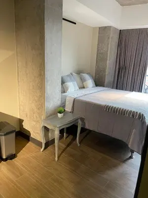a bedroom with a large bed and a table at Apartment with a balcony El Tesoro in Medellín