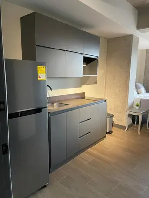 a kitchen with a refrigerator and a sink at Apartment with a balcony El Tesoro in Medellín
