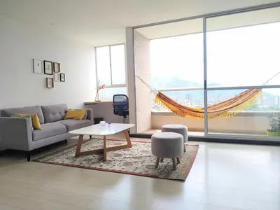 a living room with a couch and a table at Next to natural reserve, amazing views! in La Estrella