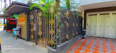a fence with a plant on it next to a building at COMODO APARTAMENTO WIFI-COWORK CERCA a ZONA TURISTICA DE MEDELLIN in Medellín