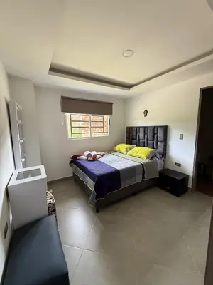a bedroom with a bed and a window in it at Primer piso con Garaje in Guatapé